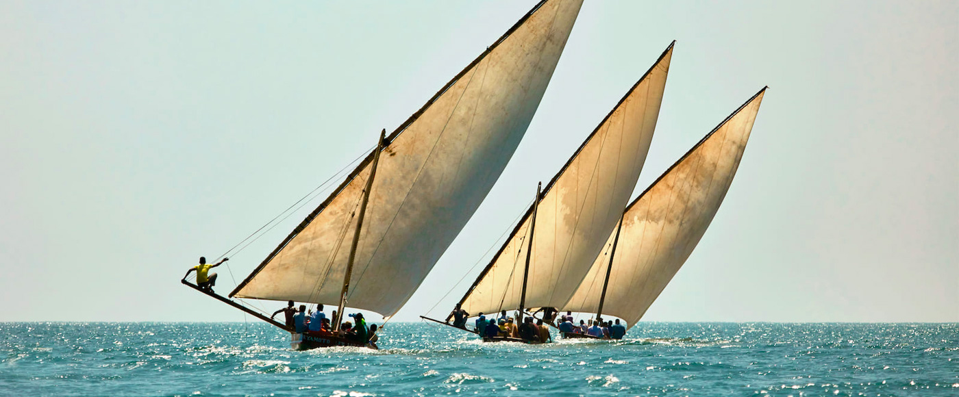 traditional dhow boats sailing on the ocean near Lamu in Kenya