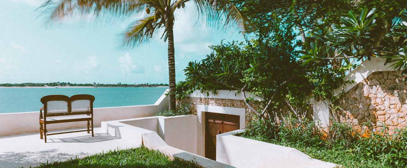 garden and terrace of the villa in Shella Beach on Lamu Island in Kenya with sea view and palm tree