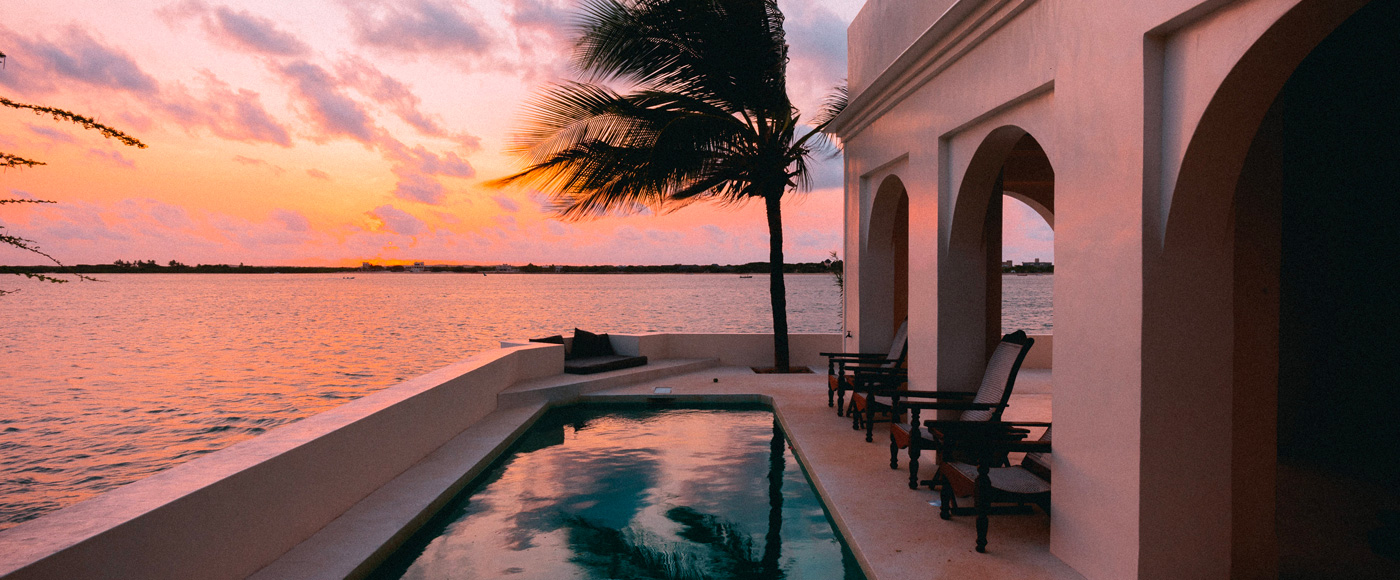 pool of the villa in Shella Beach on Lamu Island in Kenya at sunset facing the ocean