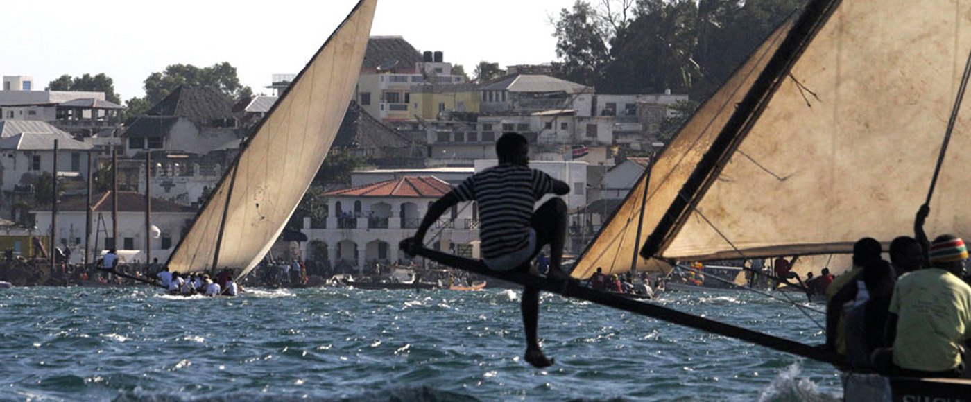 dhow regatta in front of Lamu town in Kenya with spectators
