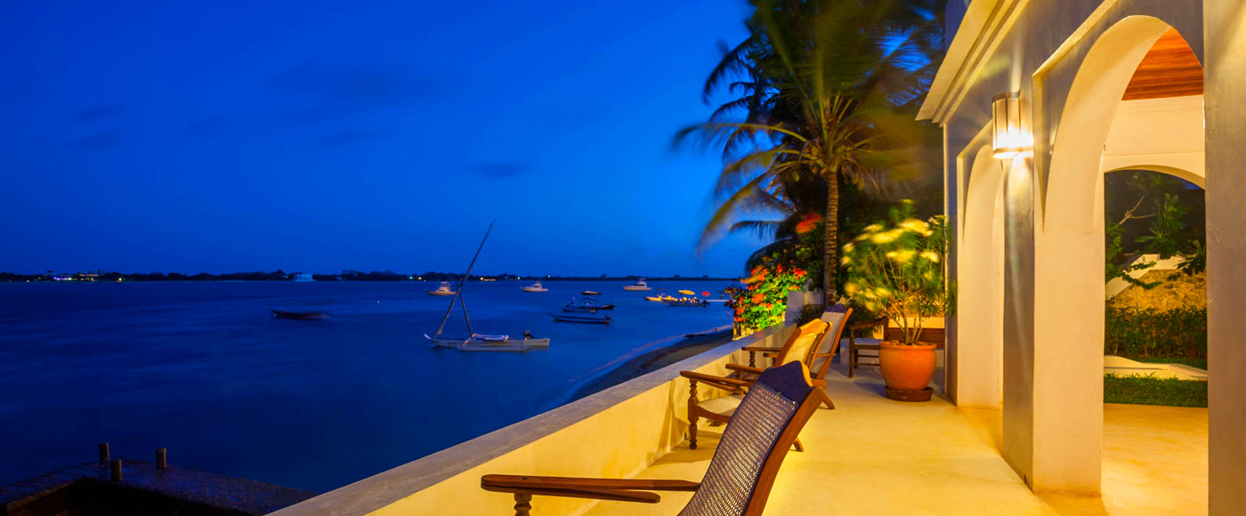 terrace of the villa in Shella Beach on Lamu Island in Kenya in the evening with armchairs facing the ocean