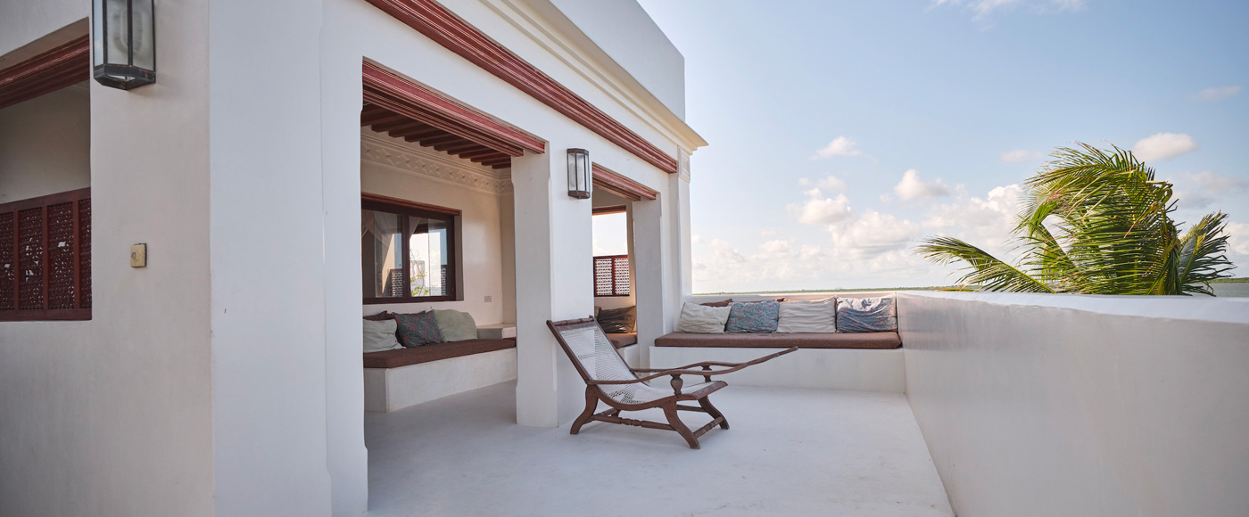 terrace of the villa in Shella Beach on Lamu Island in Kenya with armchair and ocean view